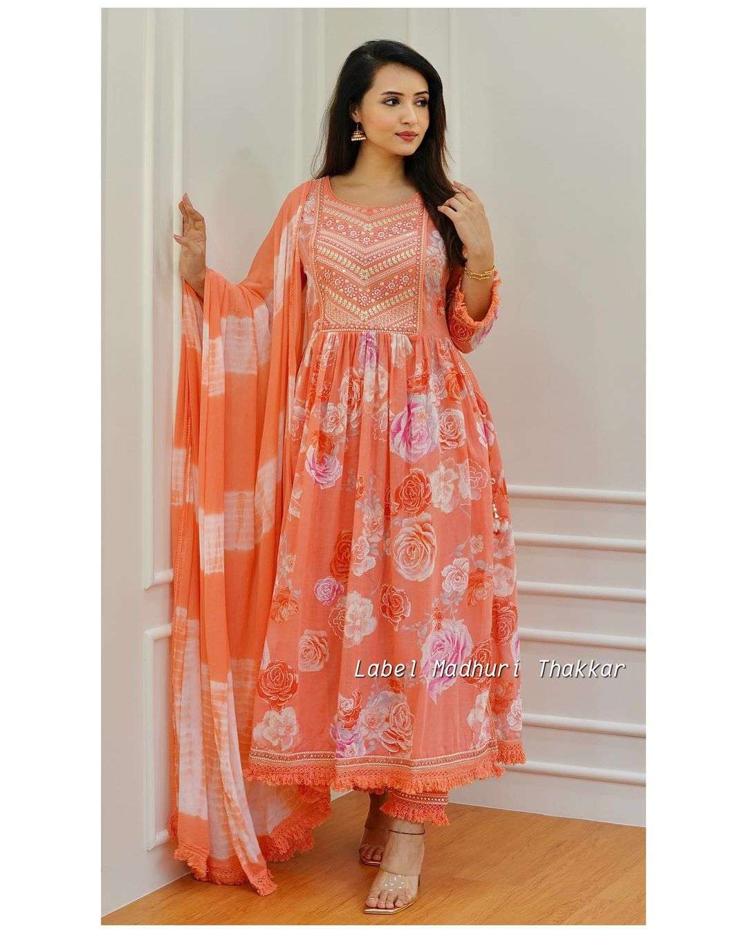 orange and yellow floral embroidered nyra cut cotton suit sets with embroidery and motifs it is paired with matching pants and chiffon tie dye dupatta