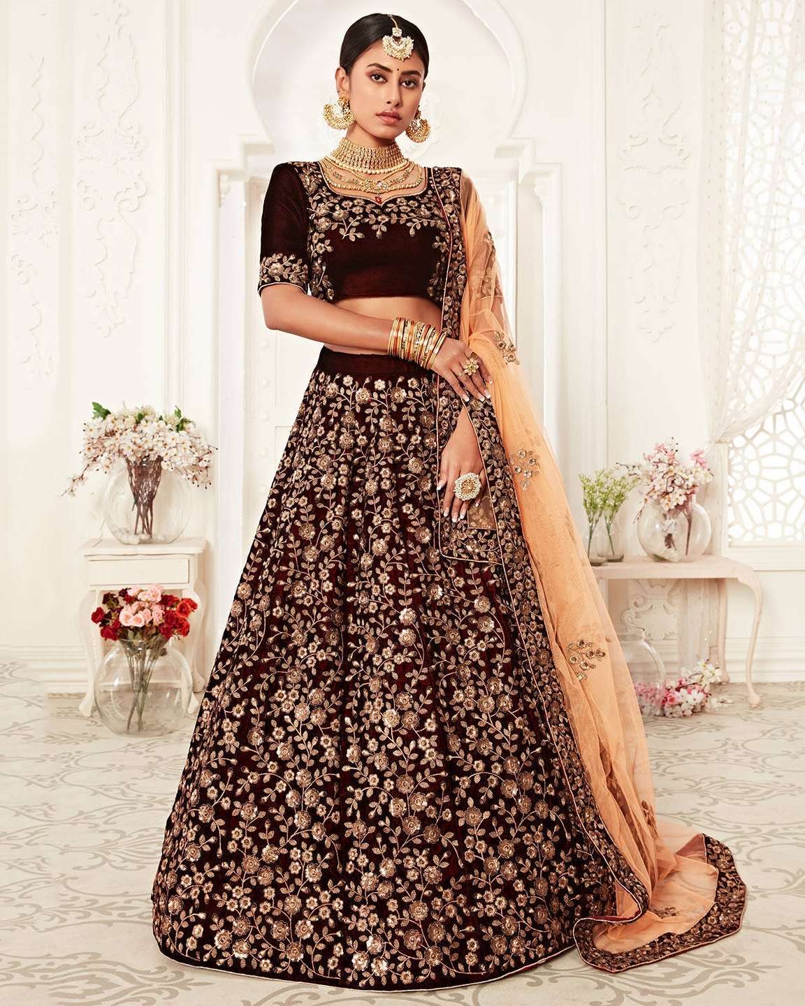 majestic maroon velvet lehenga add a touch of vintage charm to your wardrobe with this stunning maroon velvet lehenga intricately detailed with copper zari and sequin work the semi stitched skirt